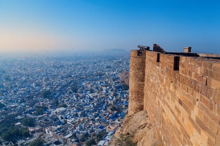 Tour package for Rajasthan featuring Mehrangarh Fort overlooking Jodhpur blue city across Rajasthan's lakes, bazaars and desert towns